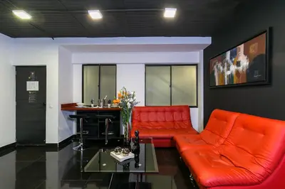 a living room with two red couches and a bar at Provenza Lofts in Medellín