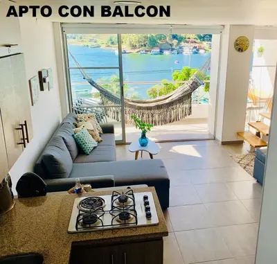 a living room with a couch and a stove at Apartamentos View, calle del Malecón frente al lago in Guatapé