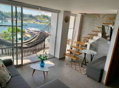 a living room with a view of a bridge at Apartamentos View, calle del Malecón frente al lago in Guatapé