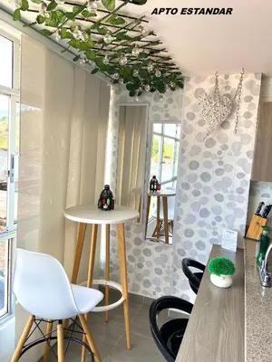 a room with chairs and a table and a mirror at Apartamentos View, calle del Malecón frente al lago in Guatapé