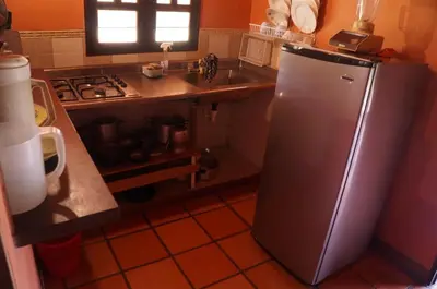 a kitchen with a stainless steel refrigerator and a sink at Hospedaje Rural Misia Emilia in Medellín