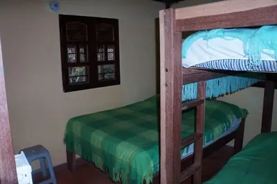 a bedroom with two bunk beds in a room at Hospedaje Rural Misia Emilia in Medellín