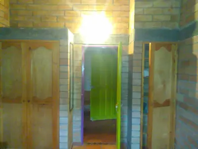 a bathroom with a shower with a light on the wall at Hospedaje Rural Misia Emilia in Medellín