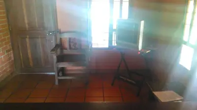 a room with a door and a chair and a window at Hospedaje Rural Misia Emilia in Medellín