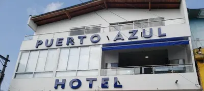 a hotel sign on the side of a building at Hotel Puerto Azul in Puerto Berrío