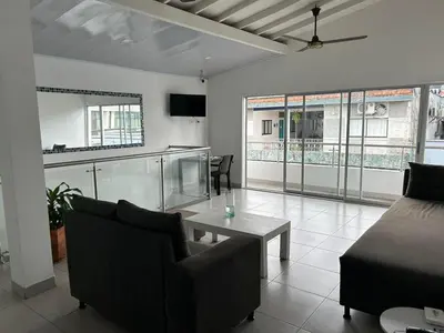 a living room with a couch and a table at Hotel Puerto Azul in Puerto Berrío