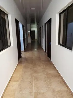 an empty hallway in an office building with a tile floor at Hotel Puerto Azul in Puerto Berrío