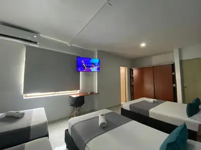 a hotel room with two beds and a flat screen tv at Ayenda 1228 Balcones de la 70 in Medellín