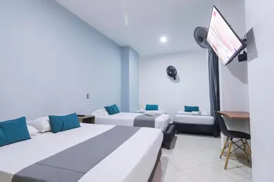a hotel room with two beds and a flat screen tv at Ayenda 1228 Balcones de la 70 in Medellín