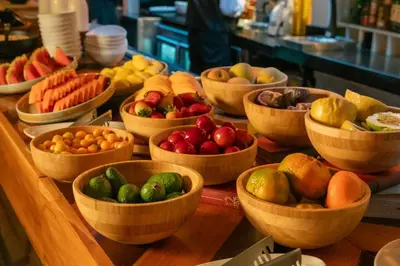 a bunch of bowls of fruits and vegetables on a table at The Click Clack Hotel Medellín in Medellín