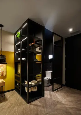 a black cabinet in a room with a toilet at The Click Clack Hotel Medellín in Medellín
