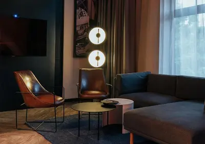 a living room with leather chairs and a couch at The Click Clack Hotel Medellín in Medellín