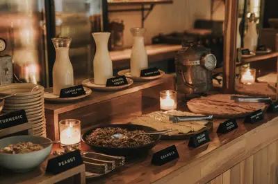 a buffet with plates of food and vases and candles at The Click Clack Hotel Medellín in Medellín