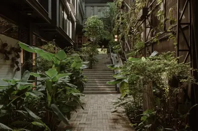 a stairway in an apartment building with plants at The Click Clack Hotel Medellín in Medellín