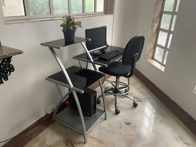 a desk with a computer and a chair in a room at Hotel Macedonia Plaza Medellin in Medellín