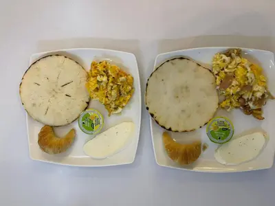 two trays of food with eggs and a tortilla at Hotel Macedonia Plaza Medellin in Medellín