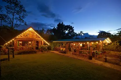 a building with lights on it at night at Cabaña Manantial del Turpial in Jardin
