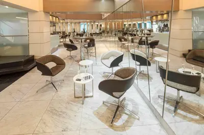 a lobby with chairs and tables in a building at Inntu Hotel in Medellín
