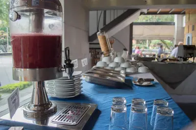 a blender sitting on a table with glasses on it at Inntu Hotel in Medellín