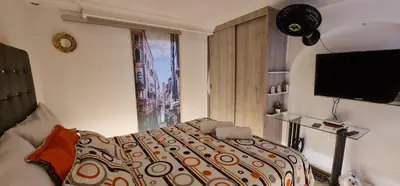 a bedroom with a bed and a large window at Studio cerca a estacion metro poblado in Medellín