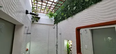 a bathroom with a shower with plants on the ceiling at Studio cerca a estacion metro poblado in Medellín