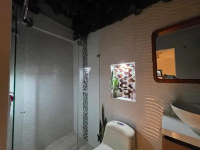 a bathroom with a shower and a toilet and a sink at Studio cerca a estacion metro poblado in Medellín