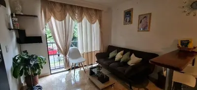a living room with a couch and a table at Studio cerca a estacion metro poblado in Medellín