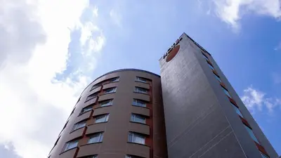 a tall building with a sky in the background at Hotel Benidorm in Manizales