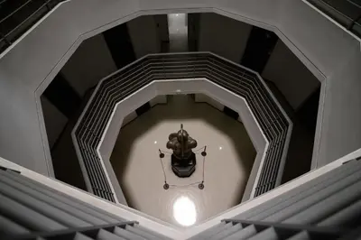 a room with a clock in the middle of a building at Hotel Benidorm in Manizales