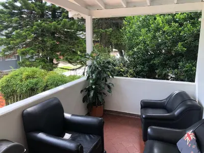a porch with two chairs and a table at Black Sheep Medellin in Medellín