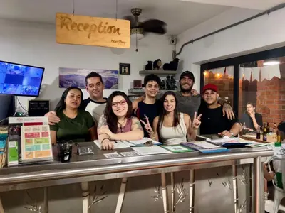 a group of people standing behind a counter at Black Sheep Medellin in Medellín