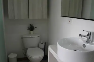 a white bathroom with a toilet and a sink at LLanogrande Aparta Estudio Puerto Bulevar in Rionegro