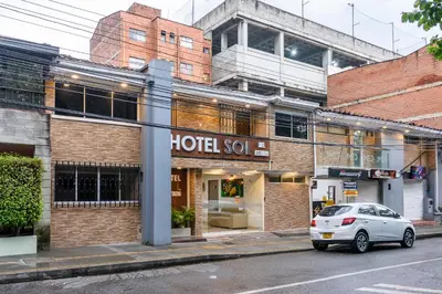 a white car parked in front of a hotel so at Hotel Sol del Estadio in Medellín