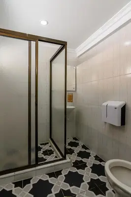 a bathroom with a shower and a toilet at Hotel Sol del Estadio in Medellín