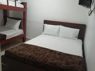 a bedroom with a bed and a bunk bed at Hotel Sol del Estadio in Medellín