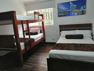 a bedroom with two bunk beds and a window at Hotel Sol del Estadio in Medellín