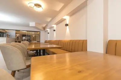 a dining room with wooden tables and chairs at Hotel Balcones del Estadio in Medellín