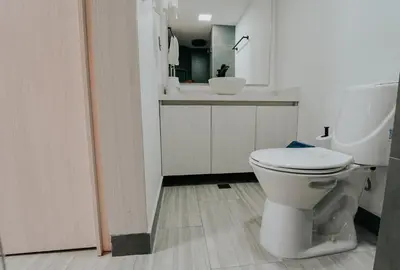 a bathroom with a white toilet and a sink at Hotel Balcones del Estadio in Medellín