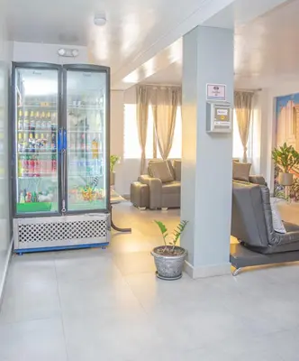 a lobby with a drink cooler in a room at Hotel Alcazar in Medellín