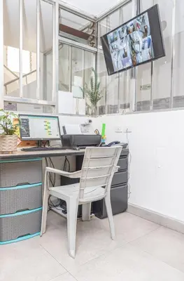 an office with a desk with a computer and a chair at Hotel Alcazar in Medellín
