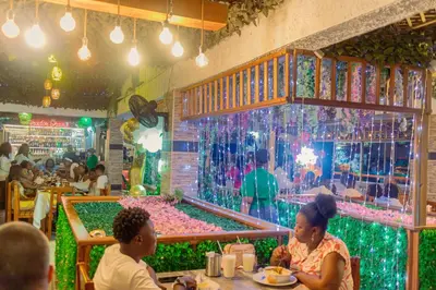 a group of people sitting at a table in a restaurant at Hotel Shaira 2 in Quibdó