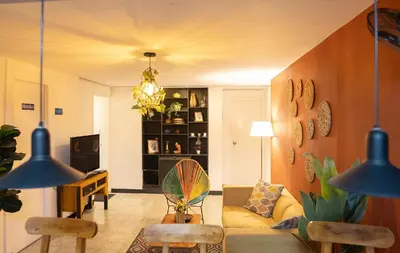 a living room with a couch and a table at Africa house-Casa Hotel Laureles-La70 in Medellín