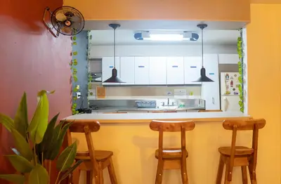 a kitchen with a counter with two stools at a bar at Africa house-Casa Hotel Laureles-La70 in Medellín