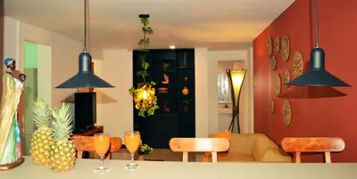 a living room with two pendant lights over a table at Africa house-Casa Hotel Laureles-La70 in Medellín
