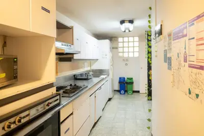 a kitchen with white cabinets and a stove at Africa house-Casa Hotel Laureles-La70 in Medellín