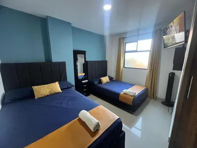 a hotel room with two beds and a window at Apartamento Ángel Namaste in Bello