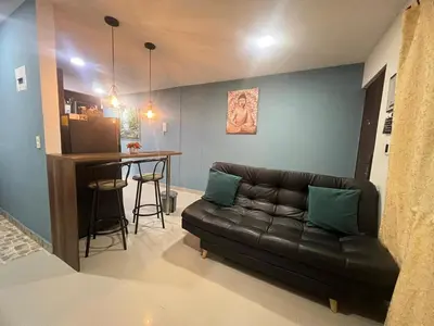 a living room with a leather couch and a table at Apartamento Ángel Namaste in Bello