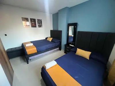 a small room with two beds and a mirror at Apartamento Ángel Namaste in Bello