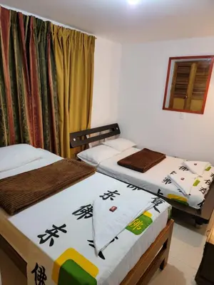 two beds sitting in a room with a window at Rosita 2 in Jardin