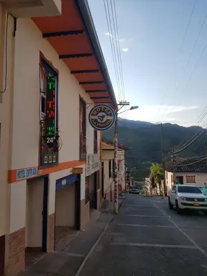 a building with a car parked on a street at Hotel La Posada in Belén de Umbría